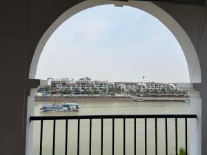 an archway with a view of a river with a boat at A59 Memory Hotel Tuan Chau in Ha Long +5 photos