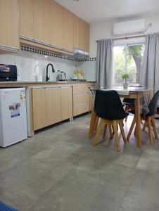 a kitchen with a table and chairs in it at YulFran in Mina Clavero +6 photos