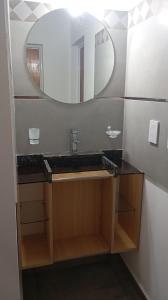 a bathroom with a sink and a mirror at YulFran in Mina Clavero