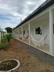 a building with hammocks on the side of it at Pousada Avalon - Lucena - PB in Lucena