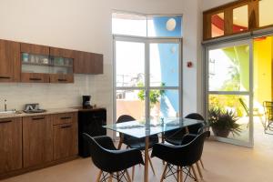 a kitchen with a dining room table and chairs at Casa Mirador 360 in Puerto Escondido +20 photos