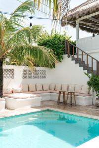 a patio with a couch and a swimming pool at The Shacks at Sandy Bay in Nusa Lembongan +38 photos
