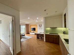 an open kitchen and dining room with a dining table at 2BR Minato Apartment, Free Swimming Pool & Gym in Hai Phong
