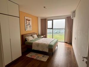 a bedroom with a bed and a large window at 2BR Minato Apartment, Free Swimming Pool & Gym in Hai Phong +17 photos