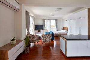 a living room with a kitchen and a bedroom at Luminous Apartments & Suites in Kathmandu +47 photos
