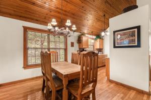 a kitchen and dining room with a wooden table and chairs at SBL14 -Mayberry Lodge in Branson West