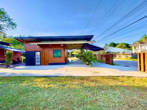 a small red building with a blue roof at Lamai Home Koh Yao Noi in Ko Yao Noi