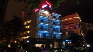 a building with blue and red lights on it at Nestorion Hotel in Athens