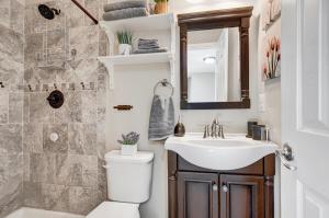 a bathroom with a toilet and a sink at Stunning Entire Home in Lanham MD close to DC in Lanham +34 photos