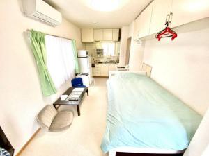 a hospital room with a bed and a kitchen at トリトン茶屋町#101#102 in Aomori