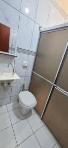 a bathroom with a toilet and a sink at Casa 3 quartos - mês com ofertas in Campo Grande