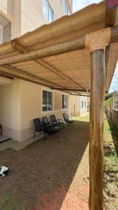 a group of chairs under a patio umbrella at Apt 102 in Parnamirim