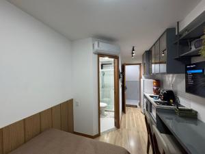 a kitchen with a sink and a counter top at Smart Pituba Studio Premium in Salvador
