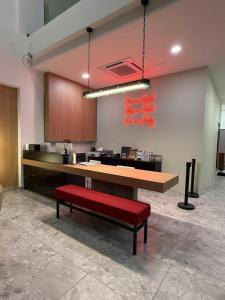 an empty office with a red bench and a counter at PureJoy Hotel Langkawi in Kuah
