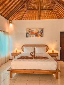 a bedroom with a bed with a heart on it at The SUN House in Balian +51 photos