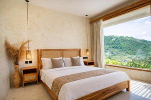 a bedroom with a large bed and a large window at Sereno Lombok Resort in Selong Belanak +63 photos