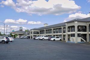 a parking lot with cars parked in front of a building at Legacy Inn - Gallatin in Gallatin