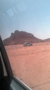 a car parked in the middle of a desert at Royal rum in Disah