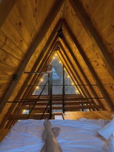 a person laying on a bed in a attic at Royal rum in Disah
