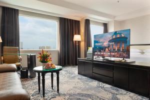 a hotel room with a bed and a large window at Four Points by Sheraton Medan in Medan
