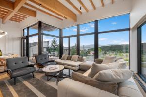 a living room with a lot of windows at Shiyuki in Furano