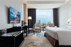 a hotel room with a bed and a large window at Four Points by Sheraton Medan in Medan +35 photos