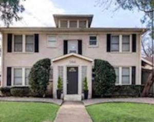 a large white house with a front door and grass at Natural Sabbatical 1 Bedroom Apartment in Dallas