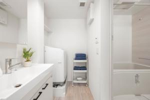 a white bathroom with a sink and a shower at 逗子海岸テラス 2階 in Zushi +35 photos