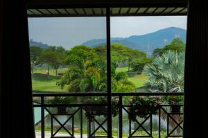 a view from a window of a golf course at Rayong Royal Residence in Ban Chang
