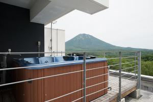 a kitchen with a sink and a mountain in the background at Snow Crystal in Kutchan