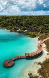 an aerial view of a beach with a wooden bridge at Aldea Mayab Luxury Residences by Lagoona in Bacalar