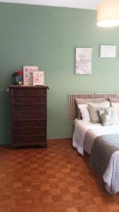 a bedroom with a bed and a dresser at QuickHome Appartamento Rovere in Biella