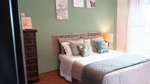 a bedroom with a bed with pillows on it at QuickHome Appartamento Rovere in Biella