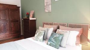a bedroom with a bed with white sheets and pillows at QuickHome Appartamento Rovere in Biella +9 photos