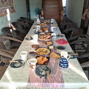 a long table with plates of food on it at Le Fortin in Samarkand +23 photos