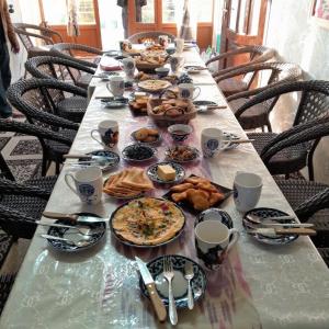 a long table with plates of food on it at Le Fortin in Samarkand