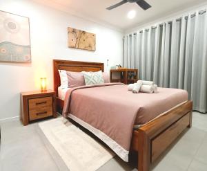 a bedroom with a bed with a teddy bear on it at Executive Studio - Private Parking in Holmview