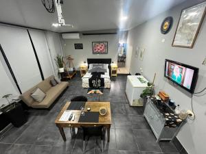 a large living room with a couch and a tv at Quincho cervecero in San Fernando del Valle de Catamarca