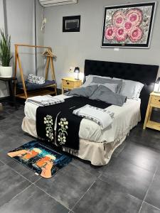 a bedroom with a bed and a rug on the floor at Quincho cervecero in San Fernando del Valle de Catamarca +34 photos