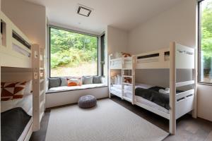 a kids room with bunk beds and a window at Song Saa Chalet in Niseko +33 photos