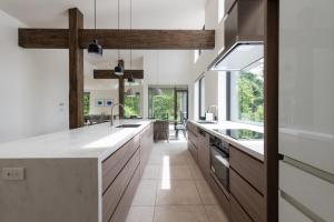 a kitchen with white countertops and wooden cabinets at Song Saa Chalet in Niseko