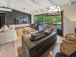 a living room with a couch and a table at The Orchard in Moonbah