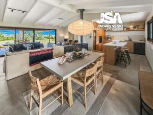 a dining room and living room with a table and chairs at The Orchard in Moonbah