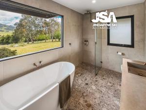 a large bathroom with a tub and a window at The Orchard in Moonbah +21 photos