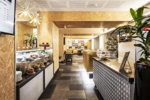 a large kitchen with a counter in a restaurant at Metro Hotel Perth in Perth