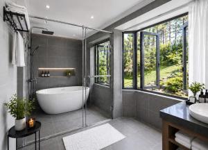 a bathroom with a bath tub and a sink at Evermist Resort DaLat in Da Lat +38 photos