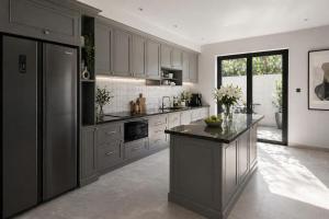 a kitchen with gray cabinets and a black counter top at Evermist Resort DaLat in Da Lat