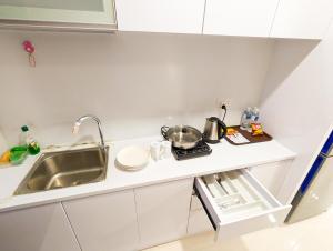a small kitchen with a sink and a counter top at Lovina Spacious Double Studio at Formosa Nagoya in Jodoh