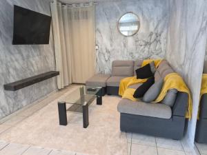a living room with a couch and a table at Oya - Destination Guyane in Macouria