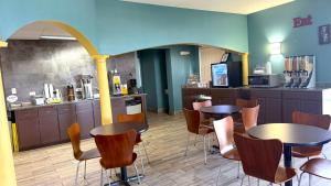 a restaurant with two tables and chairs and a counter at Super 8 by Wyndham Marianna I-10 in Marianna